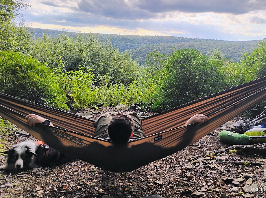 Vico Bertogli in his Hammock with dog Rush while backpacking
